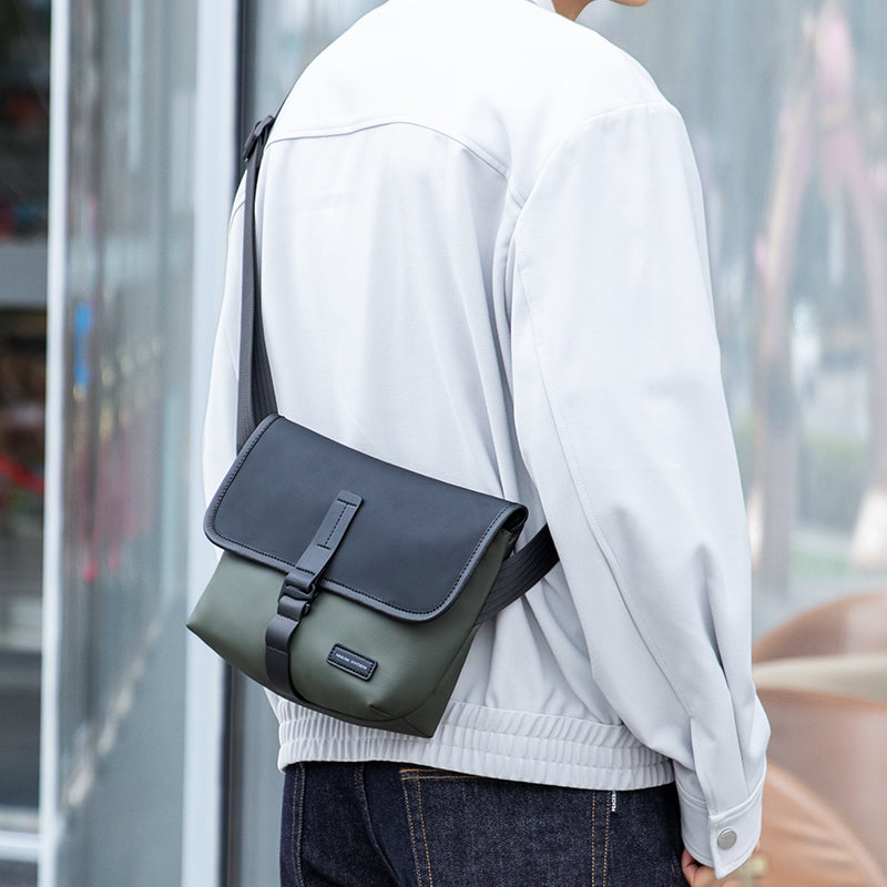 Mark Ryden olive crossbody bag worn by modern traveler outdoors