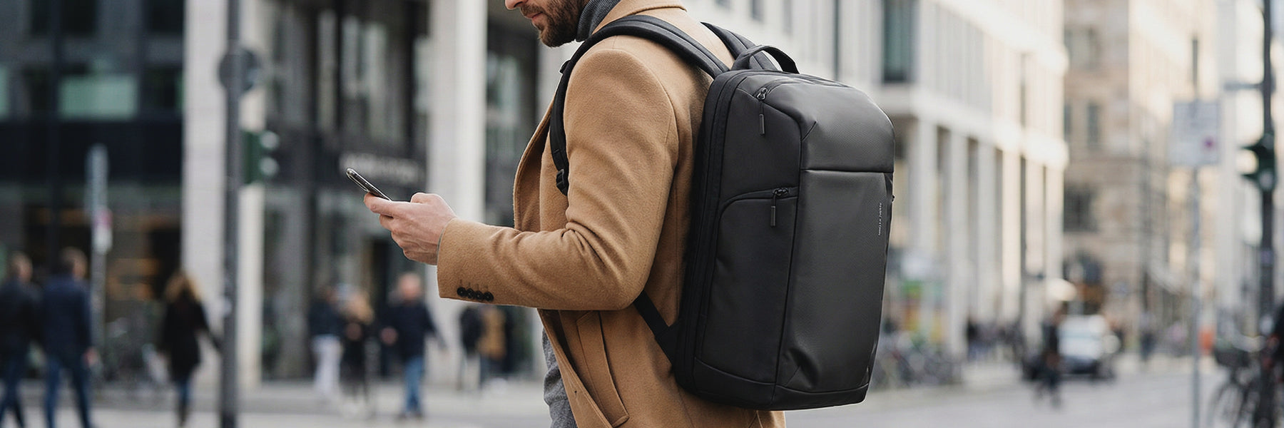 Mark Ryden black anti-theft backpack on modern traveler in city
