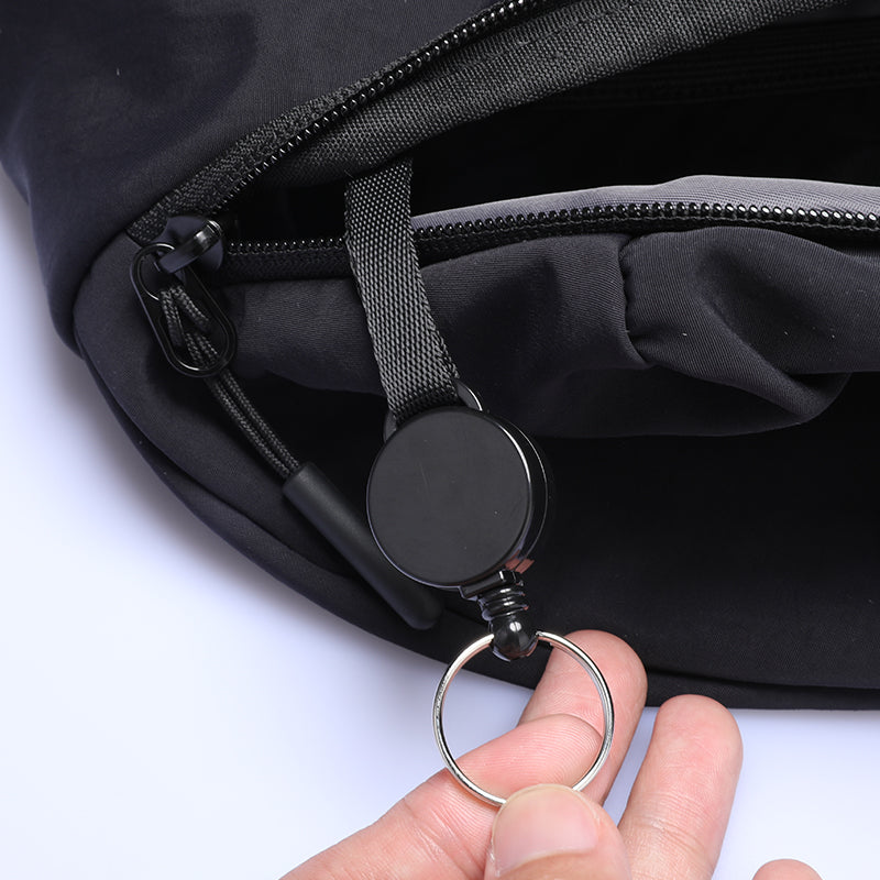 Mark Ryden Global ChillFlex sling bag with black zipper and retractable badge holder with key ring