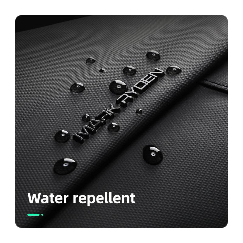 Black textured MARK RYDEN UrbanStride Compact City Explorer’s Satchel Crossbody Bag with water droplets demonstrating water repellent feature.