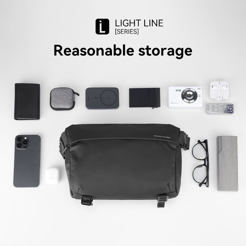 Black Mark Ryden CityWalk large capacity spacious waterproof messenger bag with YKK zipper, surrounded by phone, wallet, camera, and other essentials to demonstrate storage capacity.