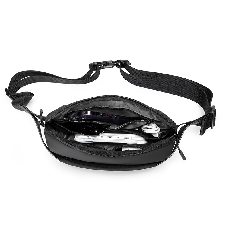 Mark Ryden black anti-theft waist bag with tech accessories inside, modern travel design
