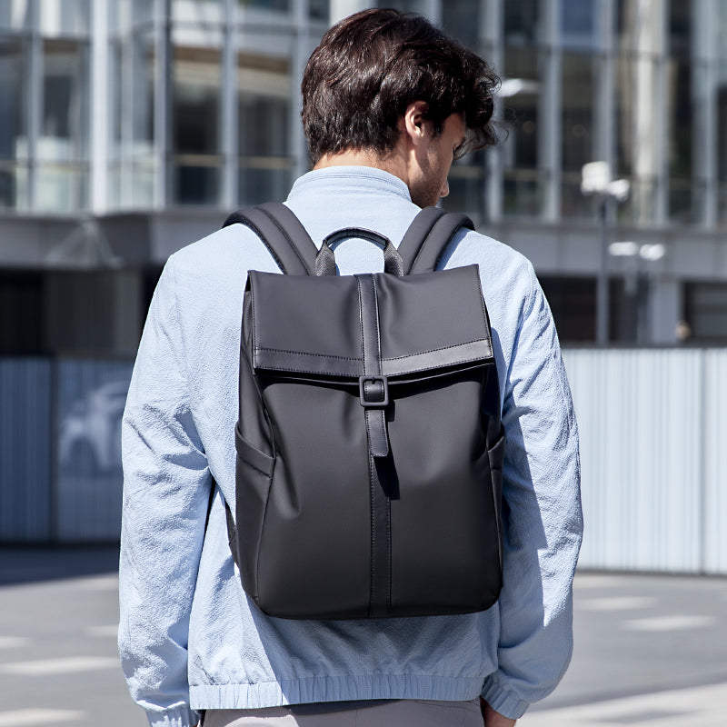 Professional stylish black lightweight backpack worn by man in urban setting - Mark Ryden Global