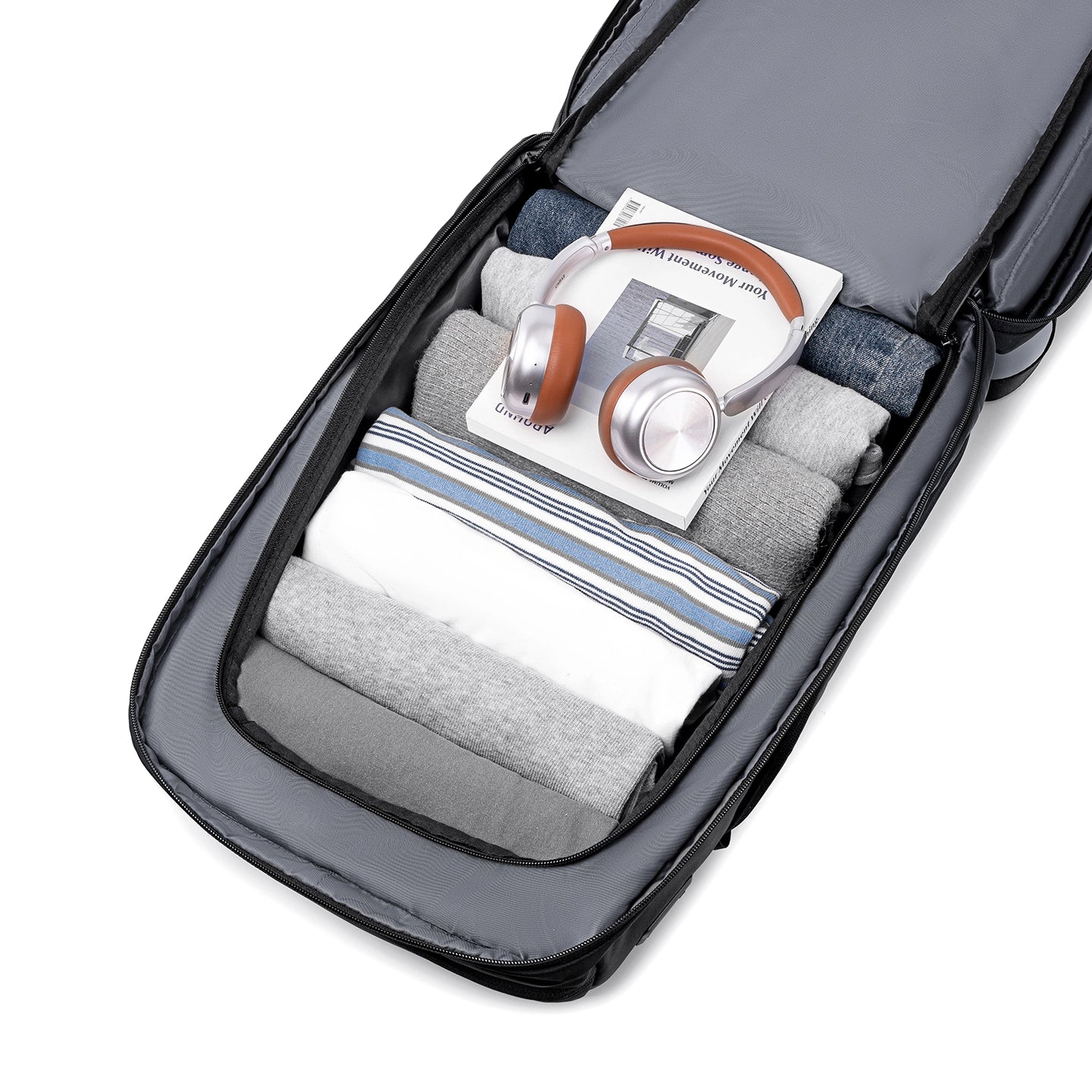 Vanguard splash-proof backpack with USB port for commuters, organized packing with clothes, headphones & book