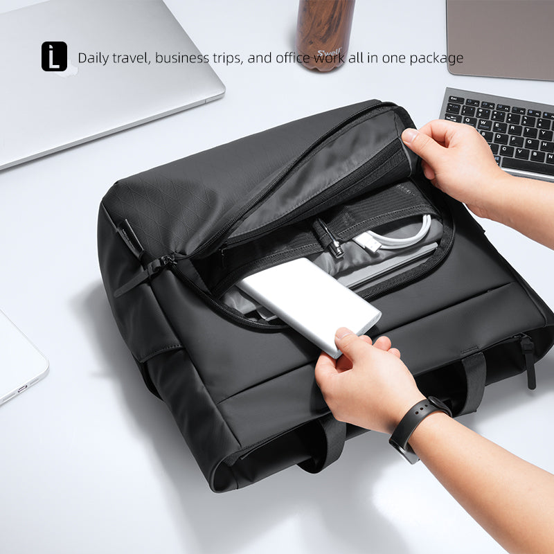 Mark Ryden Global's black tech-integrated messenger bag with dedicated charger compartment, holding devices