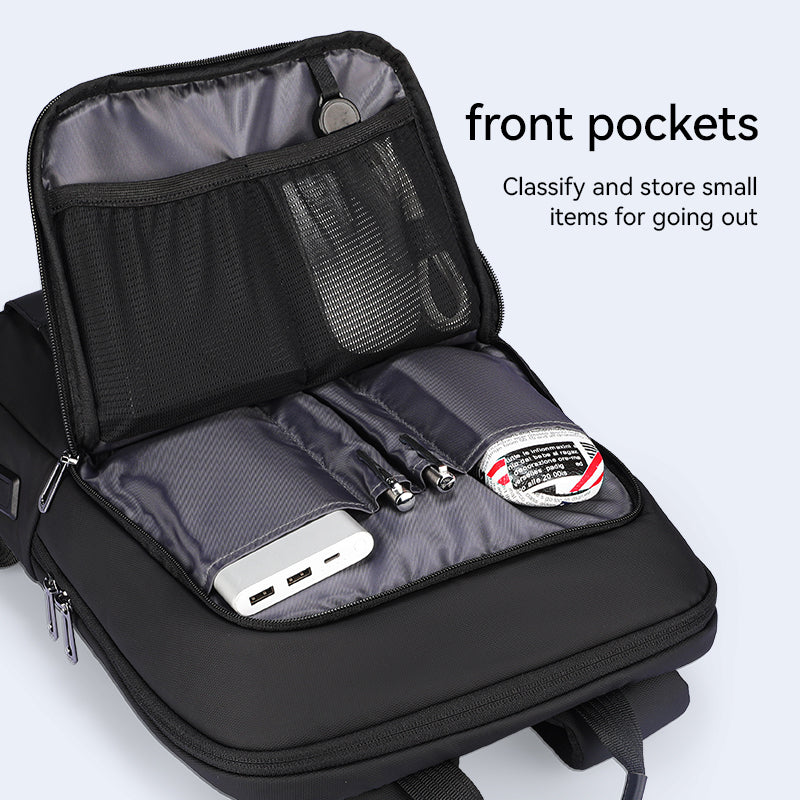 Black water-resistant UrbanLite Pro business travel backpack with open front pockets displaying mesh and fabric compartments holding a power bank, pens, and small items.