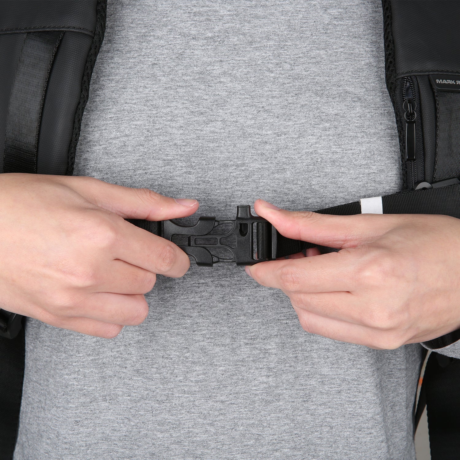Mark Ryden anti-theft backpack adjustable buckle on gray shirt