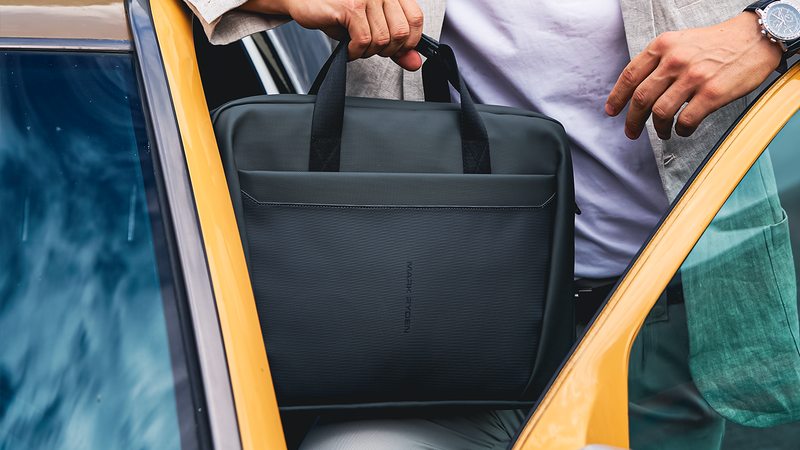 Mark Ryden black anti-theft bag being carried into taxi during Christmas