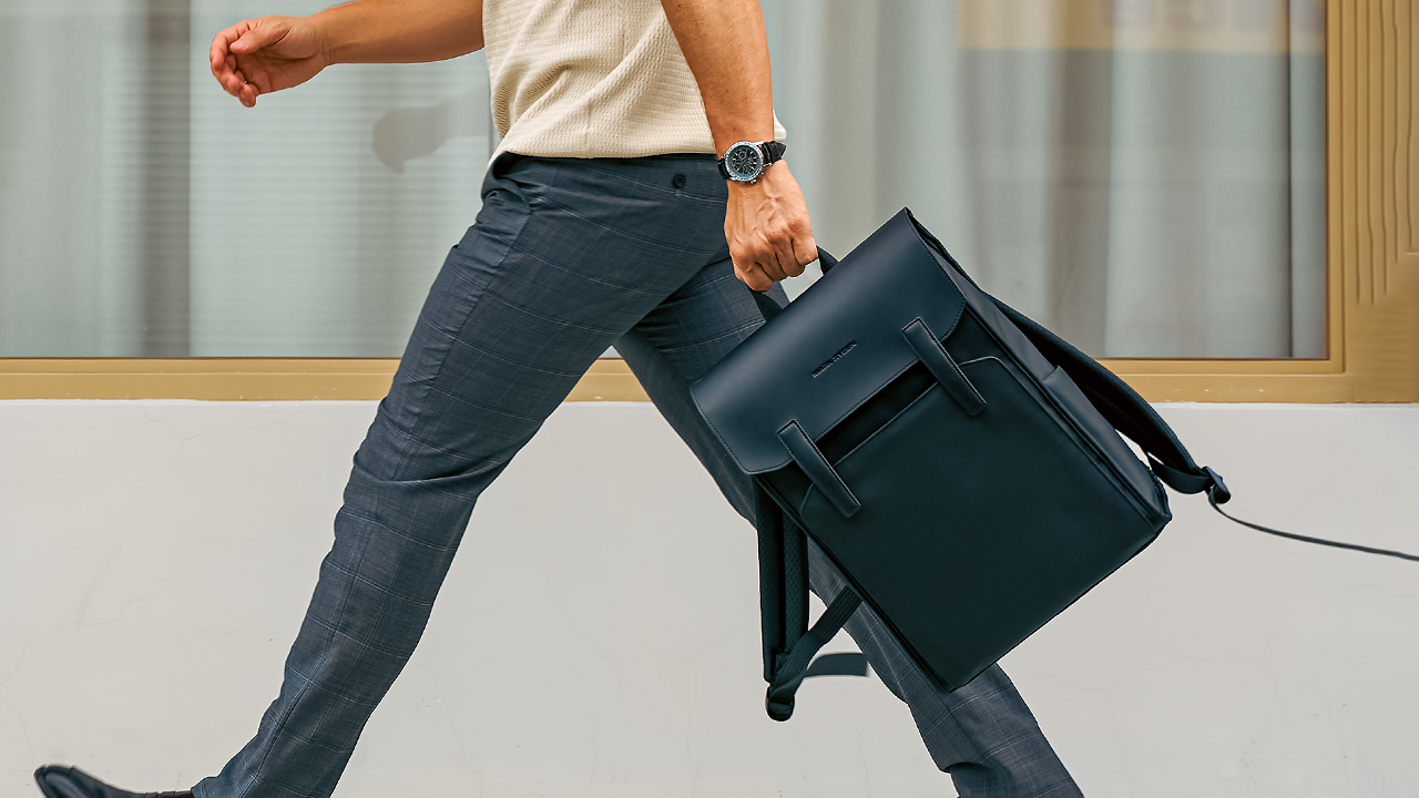 Modern traveler carrying Mark Ryden black anti-theft backpack