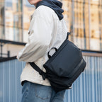 Mark Ryden Global: Modern traveler wearing sleek black anti-theft messenger bag