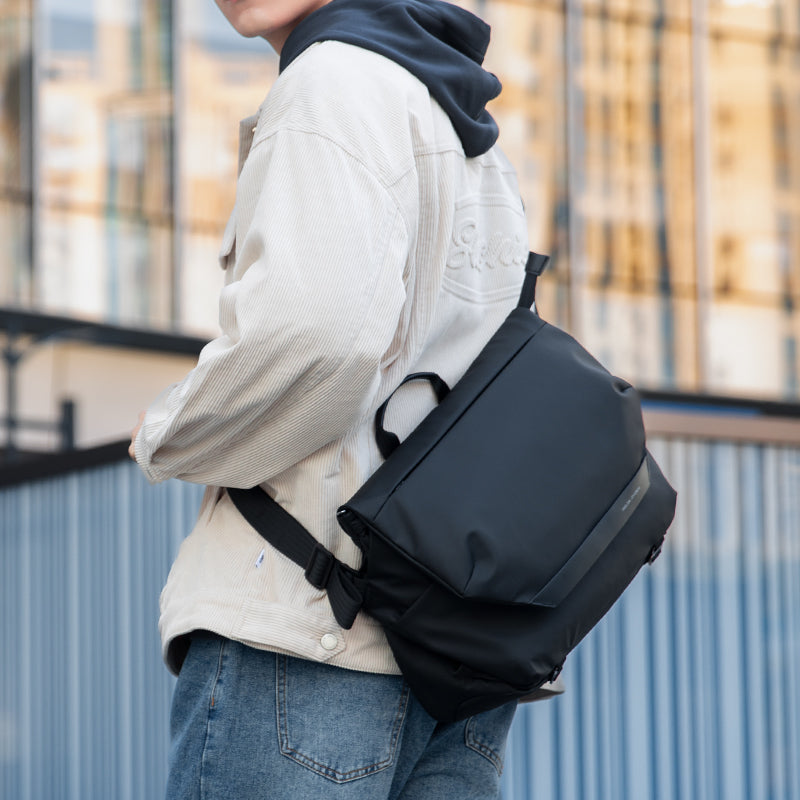 Mark Ryden Global: Modern traveler wearing sleek black anti-theft messenger bag