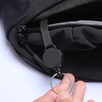 Mark Ryden Global ChillFlex sling bag with black zipper and retractable badge holder with key ring