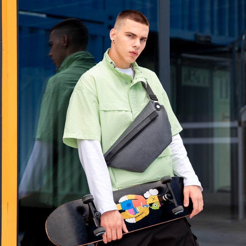 Pelmeen gray chest bag with streamlined design, textured material, ideal for daily urban travel, from Mark Ryden Global.