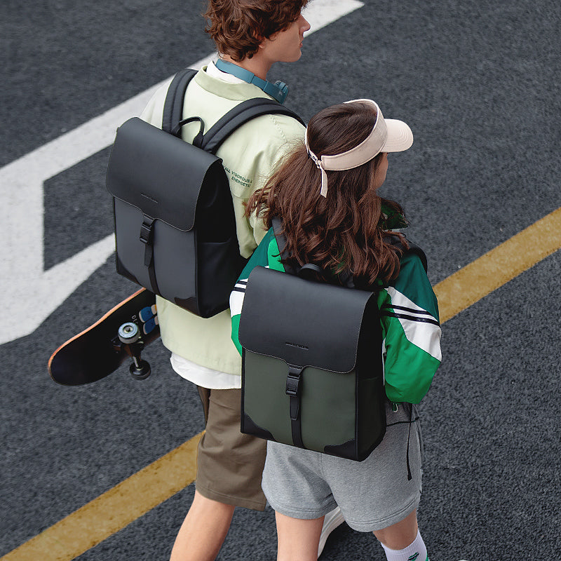 MUKE I school style classic business backpacks (black & olive) worn by young adults walking on paved street | MARK RYDEN Global