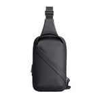 Black waterproof crossbody bag with sleek design, diagonal strap, and Mark Ryden branding—simple, clean, large capacity for modern travelers.