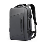 Dark gray Mark Ryden Expandos versatile expandable laptop backpack with front zipper pocket, padded adjustable straps, side USB port, perfect for all-day travel.