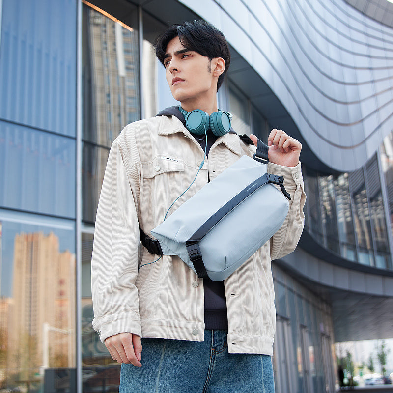 Mark Ryden Global light blue anti - theft messenger bag on model in modern city building