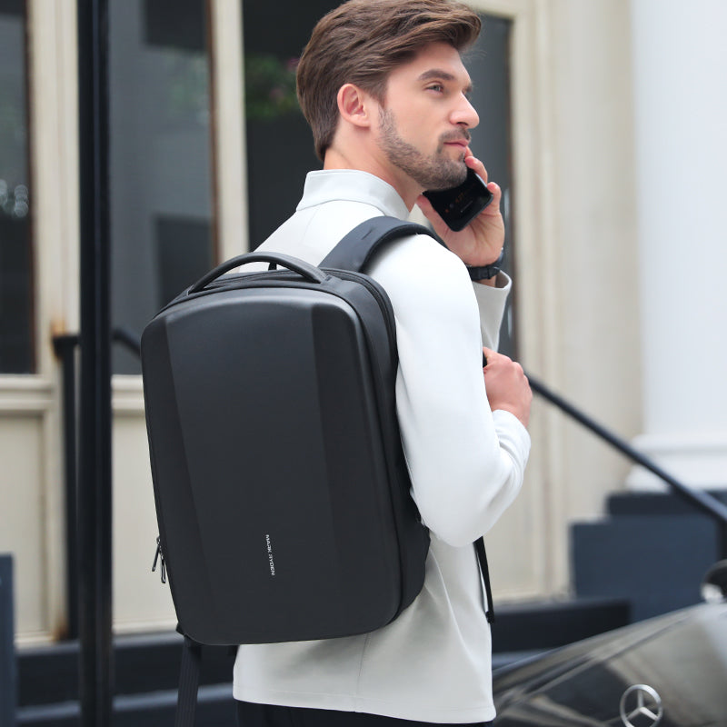 Man in white shirt with black waterproof laptop backpack talking on phone | MarkRyden Global