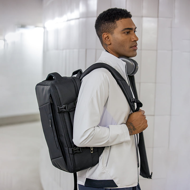 MarkRyden Global black multifunctional business backpack with YKK zipper worn by man
