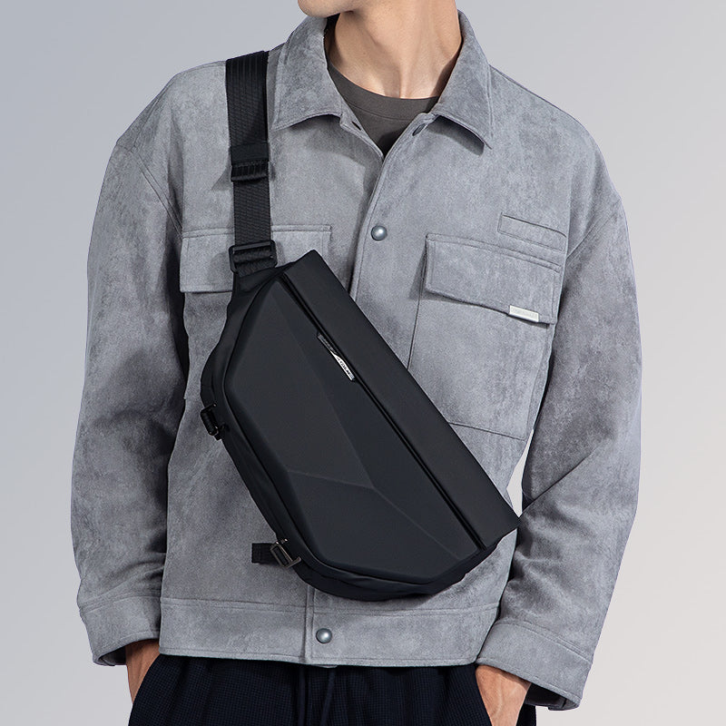 Black waterproof crossbody bag with strap, model in gray jacket - MARK RYDEN Global
