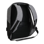 Mocchasio anti-theft backpack in gray and black with padded straps, breathable mesh back panel, and USB charging port for secure, modern travel.