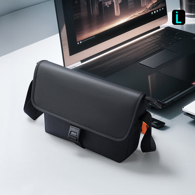 Mark Ryden Global black business casual crossbody bag with buckle on desk near laptop