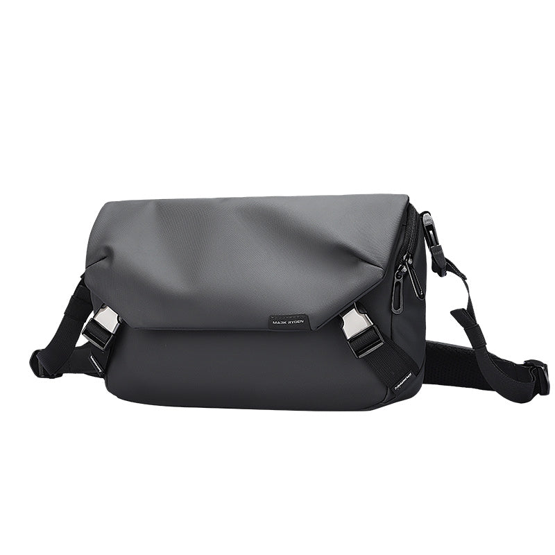 Gray flap and black body leather waterproof multifunction messenger bag by Mark Ryden, with adjustable straps, zippered compartments, and sleek design.