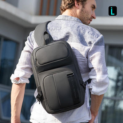 Black MARK RYDEN large capacity waterproof crossbody commuter bag worn outdoors