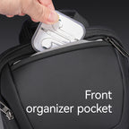 Mark Ryden Global black iPad-capable crossbody bag with front organizer pocket holding earphone case