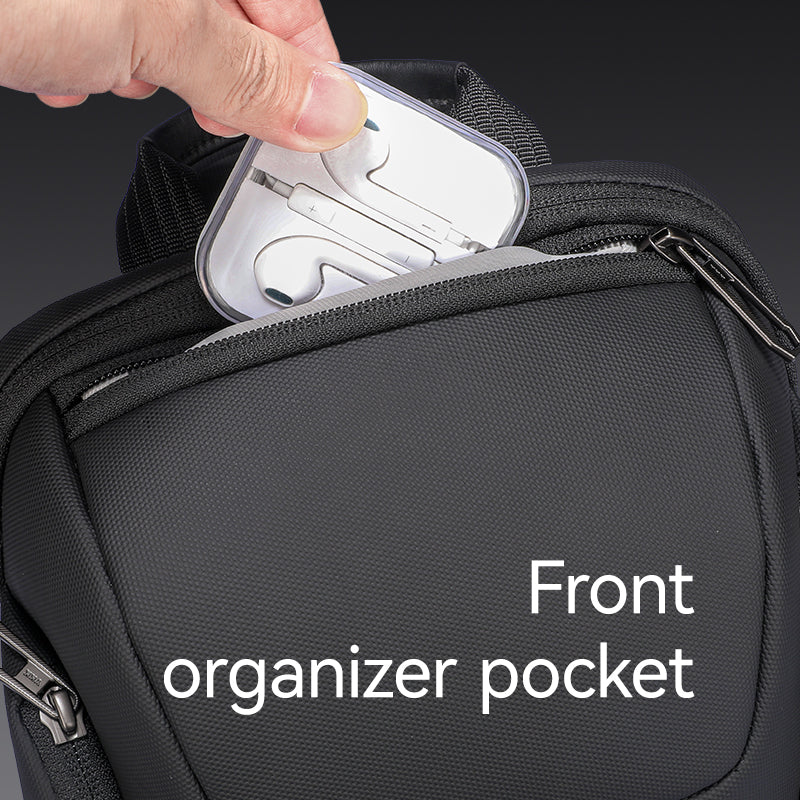 Mark Ryden Global black iPad-capable crossbody bag with front organizer pocket holding earphone case