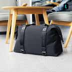 Mark Ryden black lightweight spacious duffel bag near wooden table