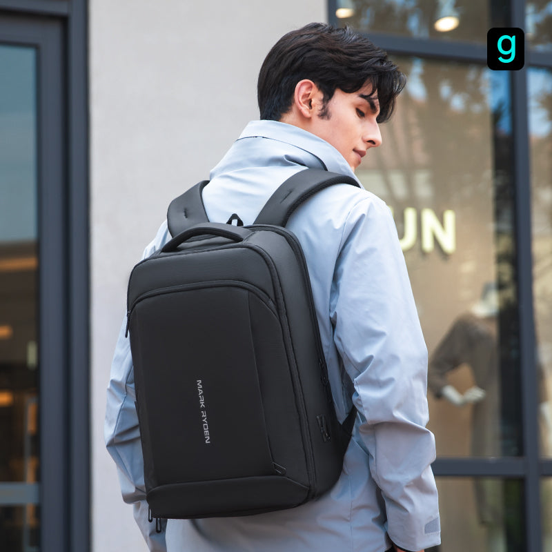 Man wearing black Mark Ryden Slim II upgraded high-capacity backpack, ideal for traveling and commuting.