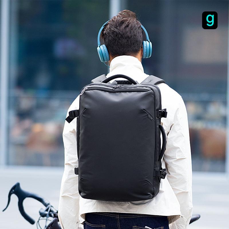 Mark Ryden Global black explorer backpack with blue headphones near bicycle
