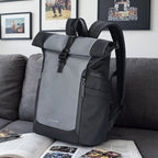Mark Ryden DynaPack gray/black laptop bag with roll-top closure on couch
