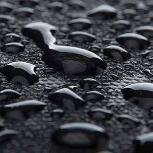 MarkRyden Global slim commuting laptop backpack with water-resistant material showing droplets