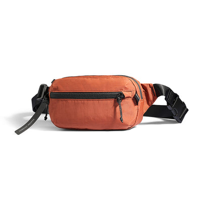 Terracotta orange AeroSling Ultra-Light Anti-Theft Crossbody Bag with black zippers, adjustable strap, and RFID-safe technology for secure travel.