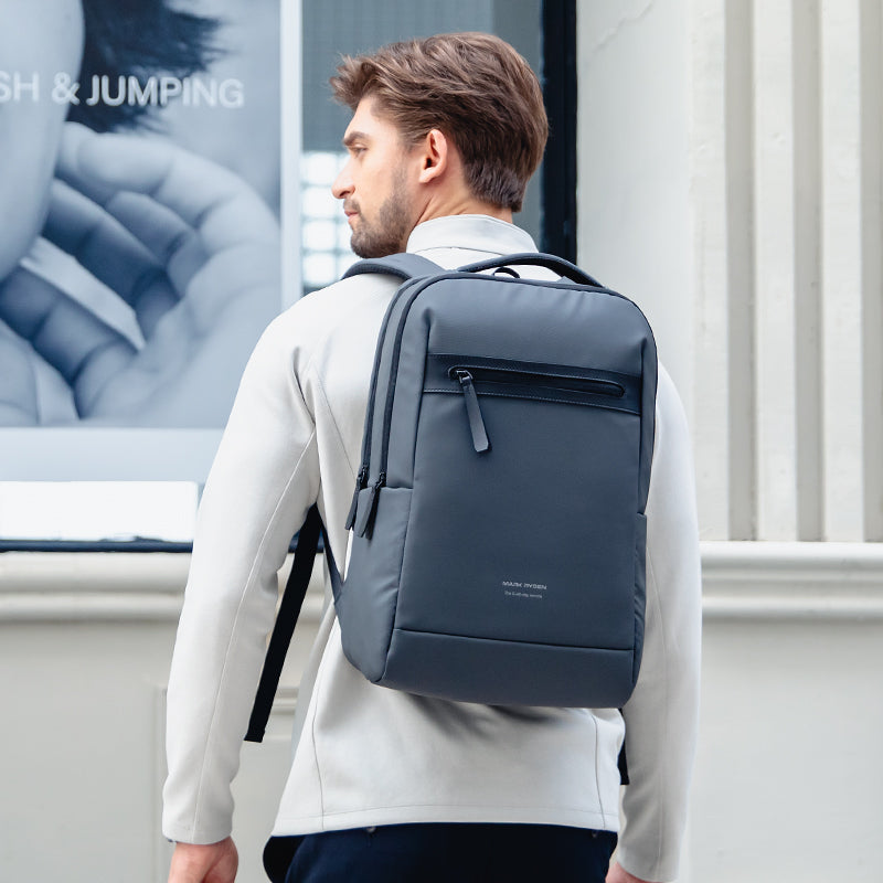 Dark gray UrbanFlex Lite backpack with computer compartment in city
