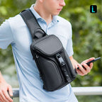 Mark Ryden Mini Adventurer sling bag - black anti-theft crossbody with air-flow tech, man using phone