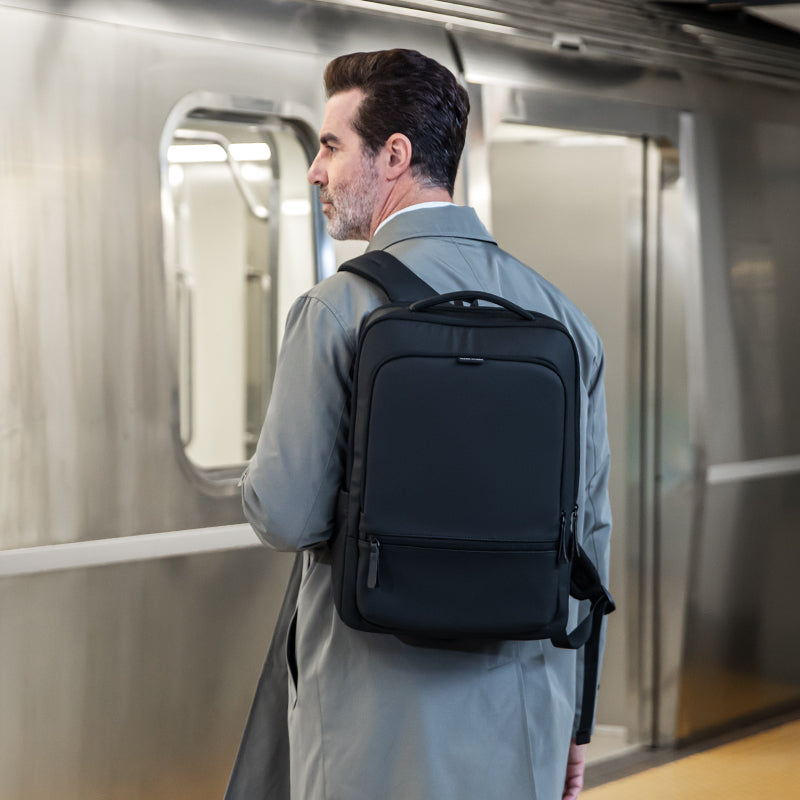 MarkRyden Global ChargeFlex smart backpack in subway station, sleek black design for modern travelers