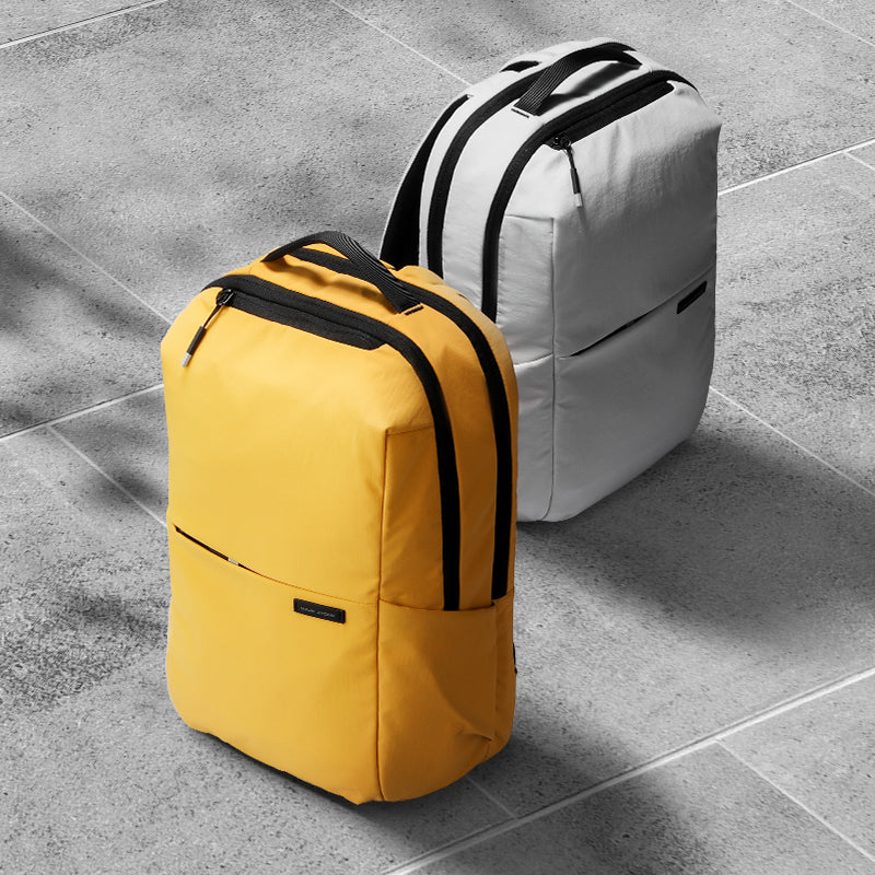 Summer Mist cool ultra-light backpacks in yellow and light gray with black accents, designed for every adventure by Mark Ryden Global.