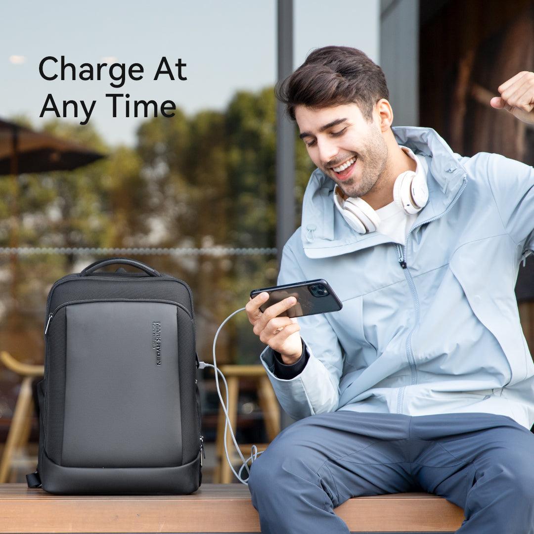 Mark Ryden Global detachable light trendy business backpack with charging feature, man using phone outdoors