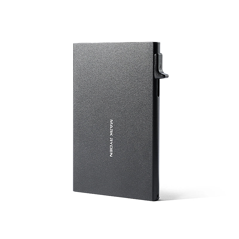 Mark Ryden VaultPop ultra-thin metal card holder in dark gray with textured surface and side lever, featuring the brand logo for secure card protection.
