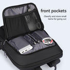 Black water-resistant UrbanLite Pro business travel backpack with open front pockets displaying mesh and fabric compartments holding a power bank, pens, and small items.