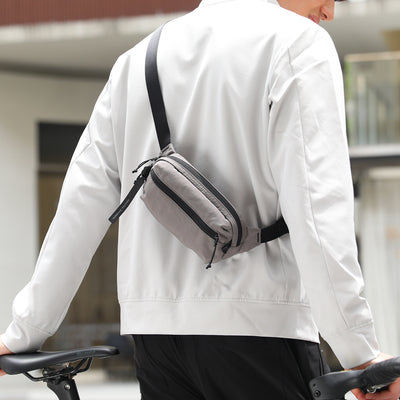 MarkRyden Global's gray anti-theft crossbody bag worn by cyclist