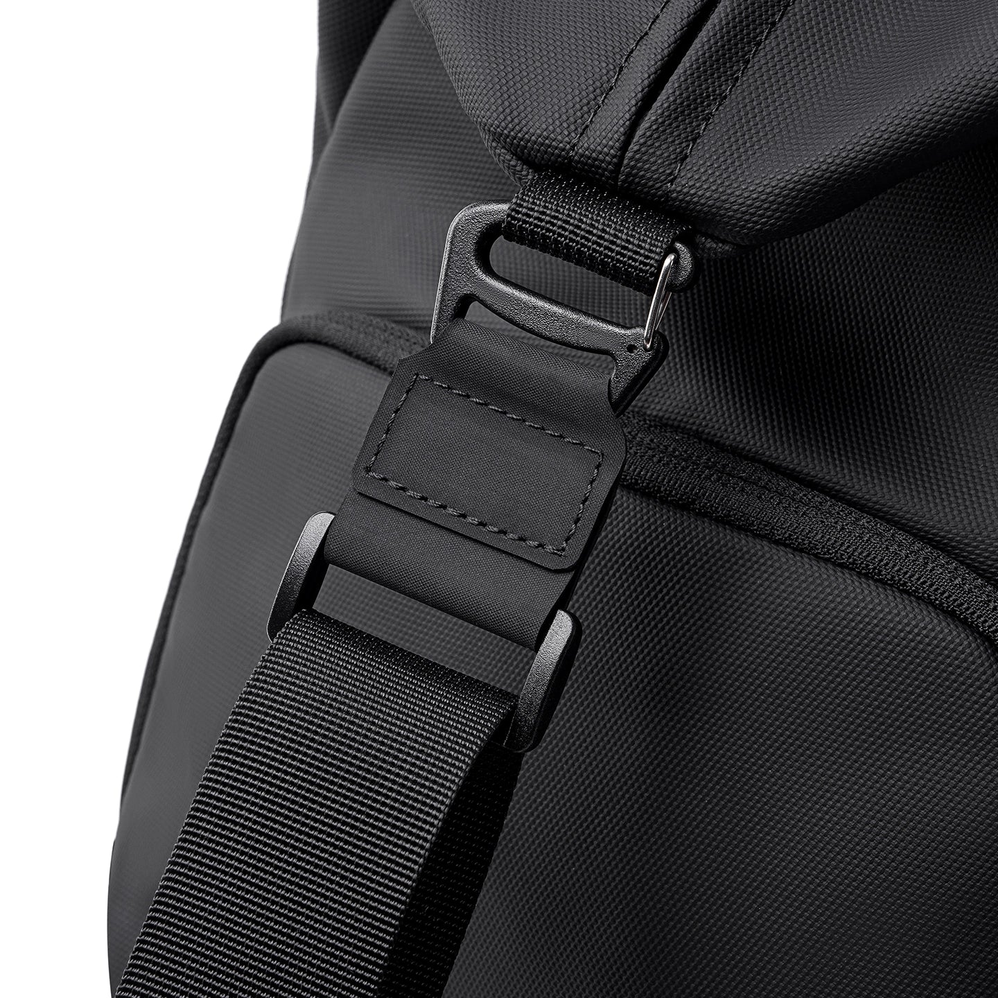 Close-up of black TransitPro Business Travel Duffel Bag for Men, large weekender carry on, showing durable strap with secure buckle and reinforced stitching.
