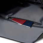 TransitPro men's business travel duffel bag interior with zippered pocket holding red and blue passports, ideal for organized weekender travel.