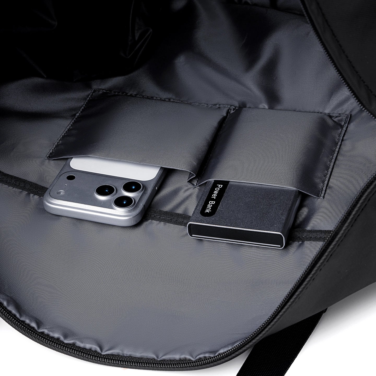 MARK RYDEN Global TransitPro duffel bag interior with silver smartphone and power bank