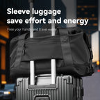 Black NomadFlex 3-in-1 Waterproof Gym Bag with sleeve luggage attachment, securely fastened to suitcase handle, featuring durable straps and zippered pocket—ideal for gym and travel.