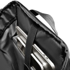 Black AeroLock lightweight backpack interior with padded laptop compartment holding silver laptop, designed for commuters with breathable features.