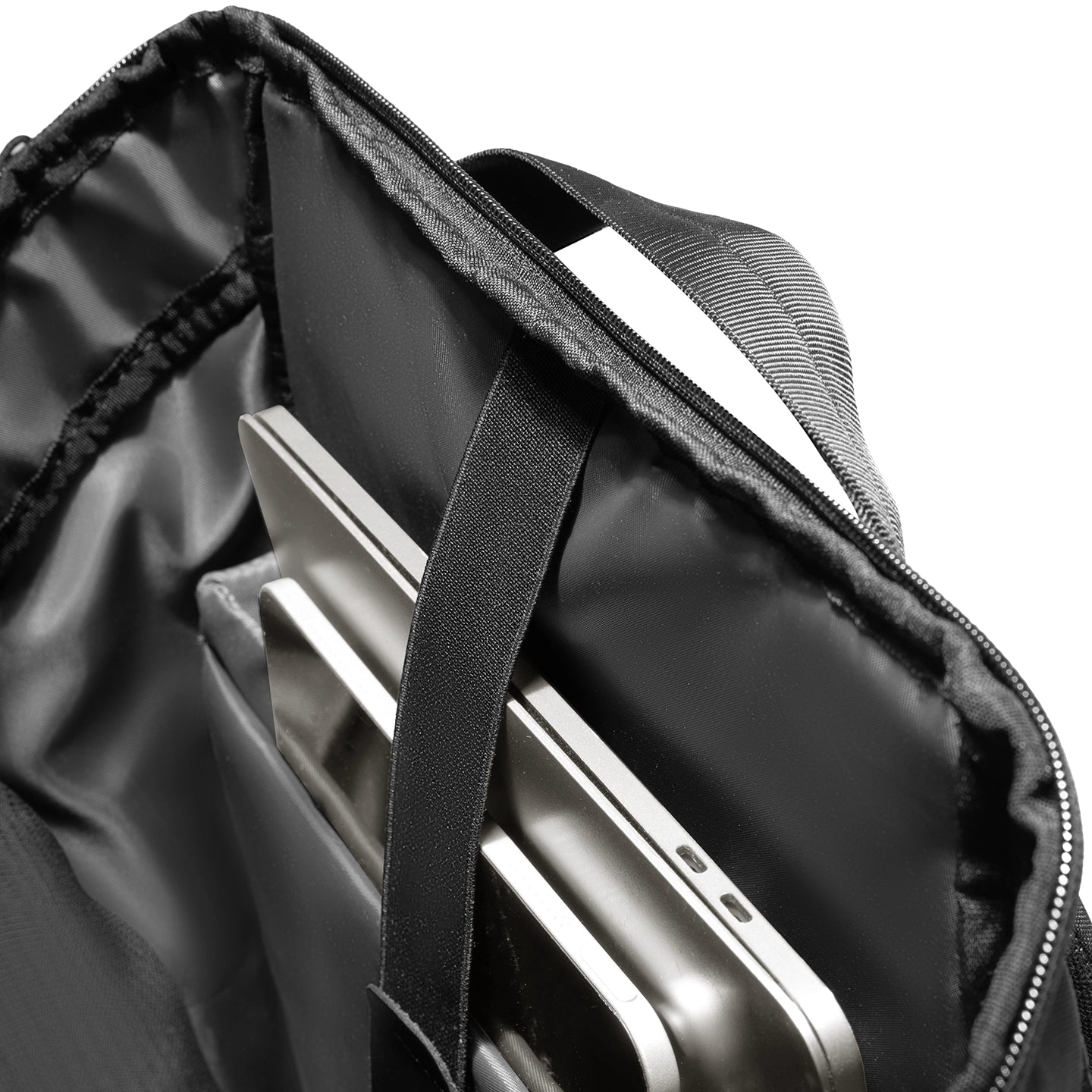 Black AeroLock lightweight backpack interior with padded laptop compartment holding silver laptop, designed for commuters with breathable features.